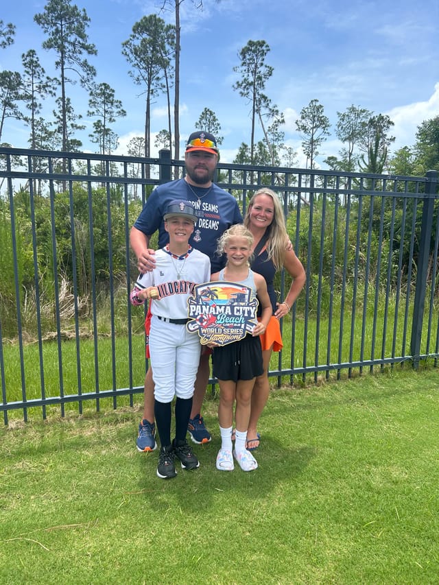 Chris Coker with his family celebrating a youth baseball championship
